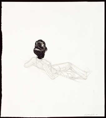 An image of a reclining woman with her back toward the viewer.