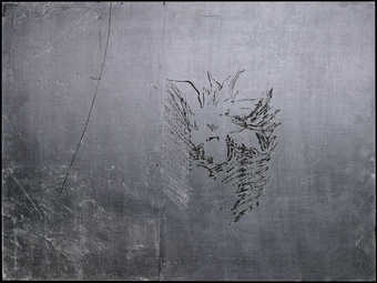 A black painted plywood panel covered with aluminum leaf.  Portions of the leaf have been removed...