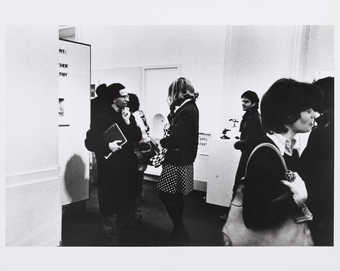 Photograph of people engaged in conversation.