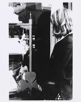 Back view of Roberta at a window.  Three leaf clover in LM image.