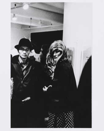 Roberta's multiple and man with eyes blacked out in art gallery.