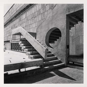 A black and white image of an exterior staircase on a modernist Indian building.