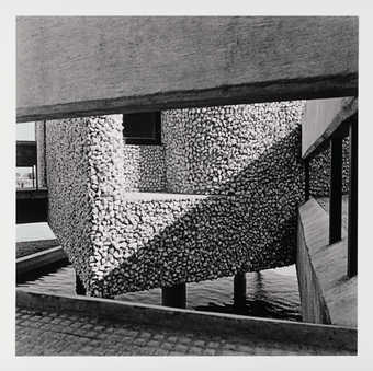 A black and white image of an exterior staircase on a modernist Indian building.