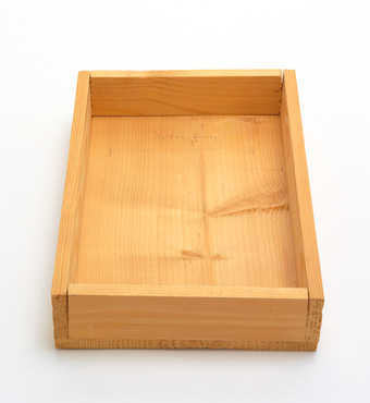 Stapled wooden box with pencilled line and handwritten additions
