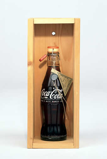 Coca-cola bottle with herb tea, plastic and rubber clamp lid; attached string with lead and paper...
