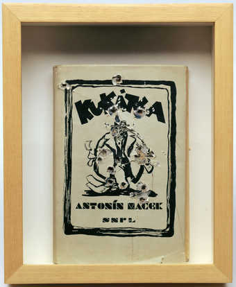 A handbound copy of "Kukátca" by Antonin Macek with 17 holes in it (all holes may not...