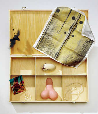 a wooden box containing objects created by various artists