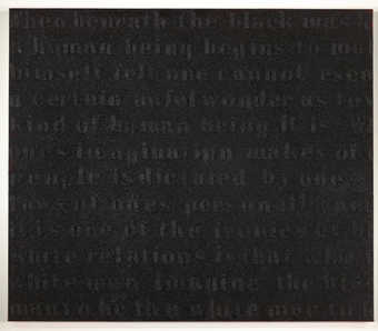 A painting that quotes text by James Baldwin covered with coal dust.