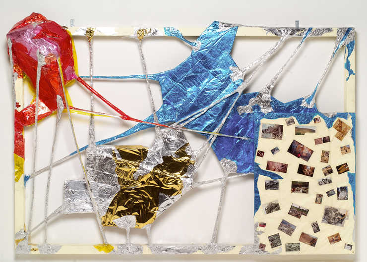 A painted wooden frame spanned and crisscrossed with plastic, aluminum foil and clear adhesive...