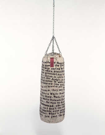 Punching bag covered with text by Muhammad Ali.  Text reads:  "Everything that the so-called...