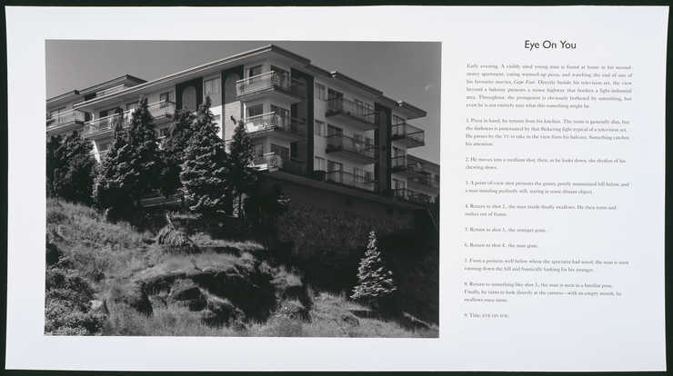 Photograph of an apartment building perched on a hill at the left side of sheet.  Cinematic...