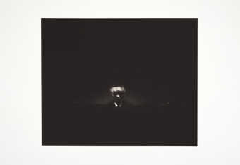 A grainy black and white image of person.