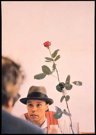 Color offset lithograph from photograph by Wilfried Bauer of Beuys with a red rose at Documenta 5...