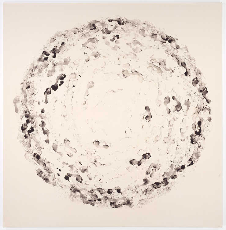 black footprints in a circle on unprimed canvas