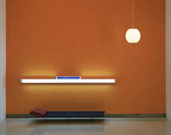 an installation containing cots, blankets, stereo boombox, tent, stools, and audio and video...