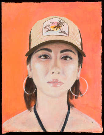 An image of a woman wearing a baseball cap and large hoop earrings.