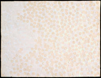 two shades of white, round adhesive labels covering an entire sheet of white paper